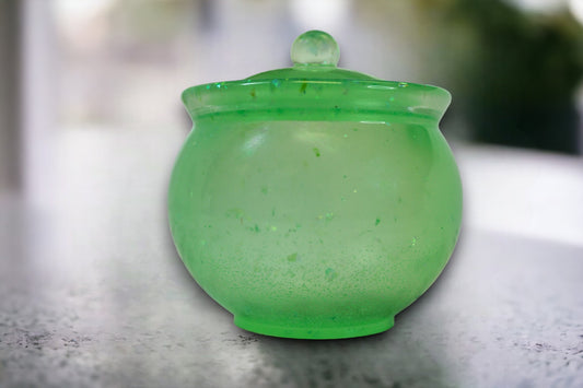 Glow in the dark iridescent green cauldron jar.